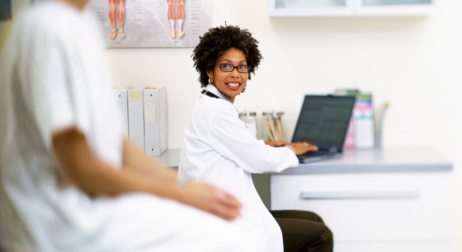 Female doctor sitting by desk