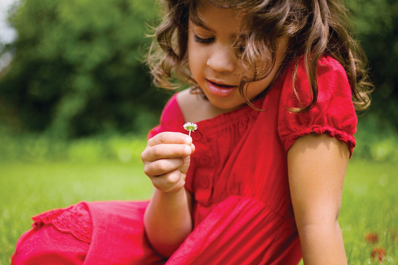 Young girl holding a flower