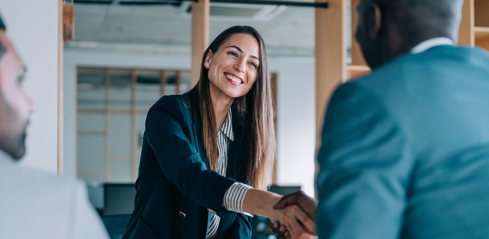 Smiling woman and man shaking hands