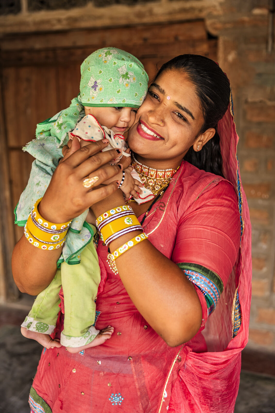 Indian mother hugging baby