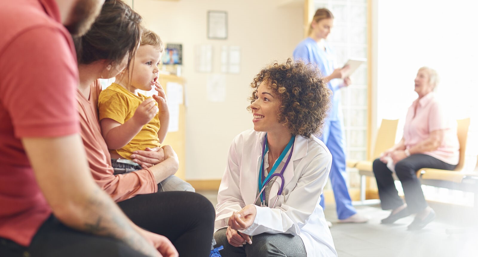 Doctor talking to child patient and parents