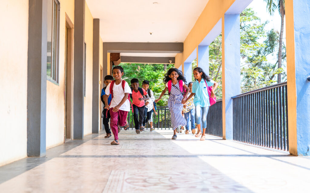 Enjoying group of kids running at school corridor for going to classroom - concept of education, reopen school, active childhood and learning