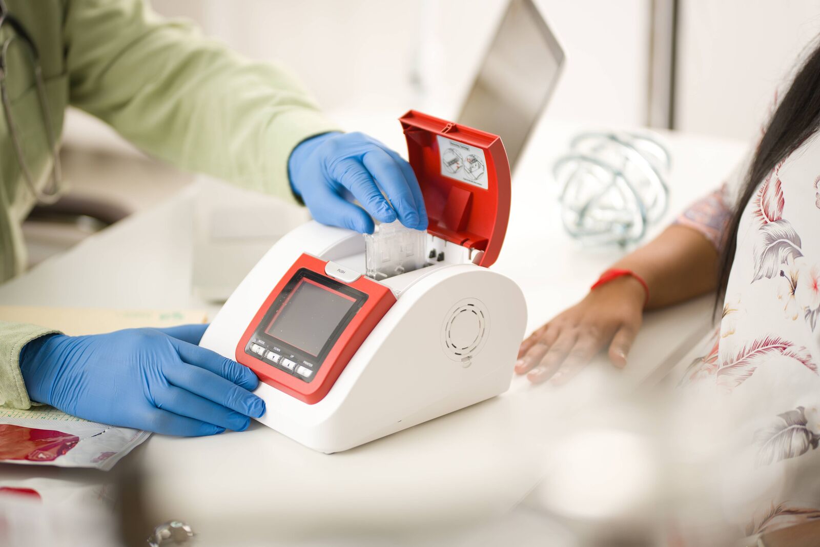 Male doctor using a HemoCue HbA1c 51 Analyzer