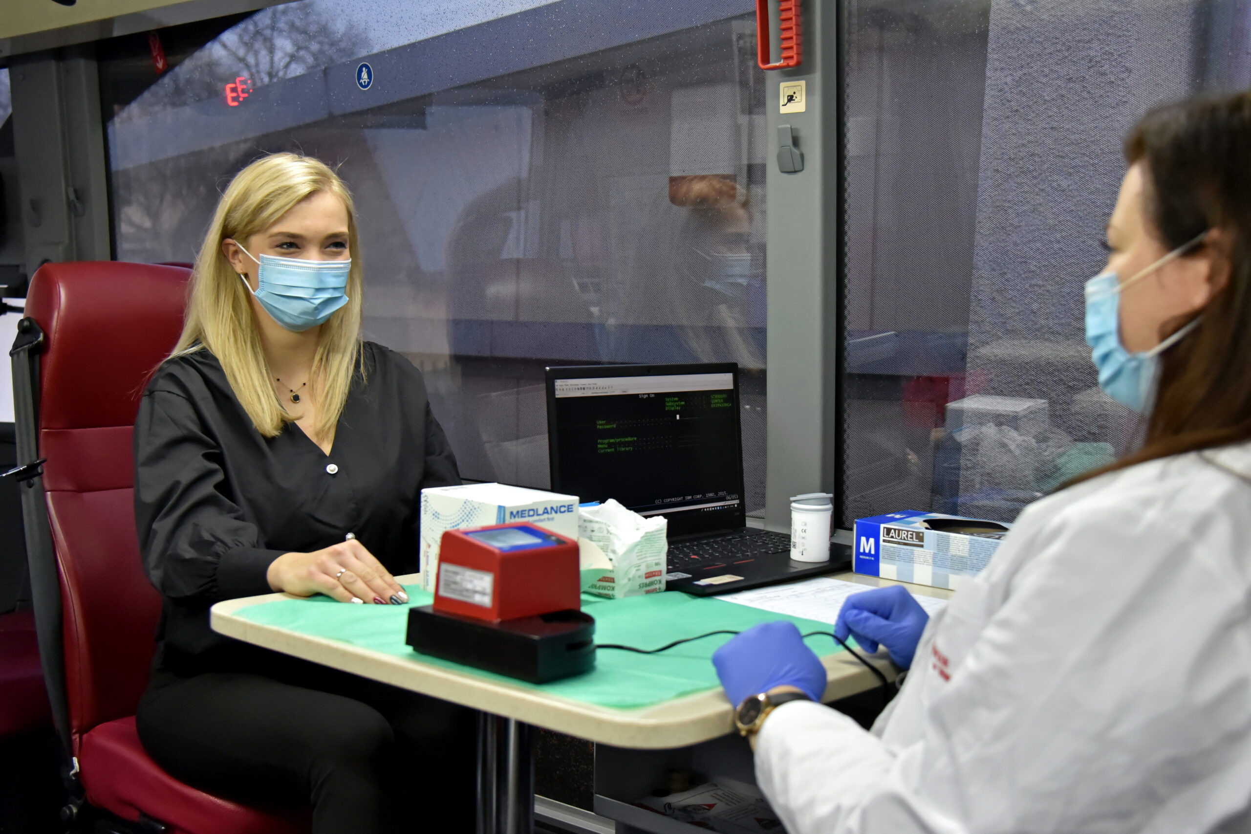 A female nurse having a talk with a female patient at a Blood Donation Drive.